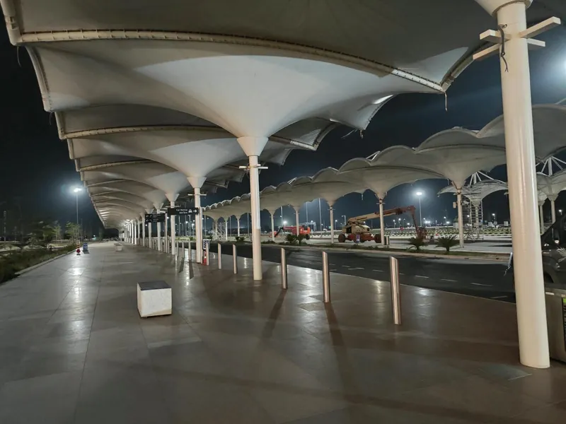 Repeating tensile canopy modules along a pedestrian walkway